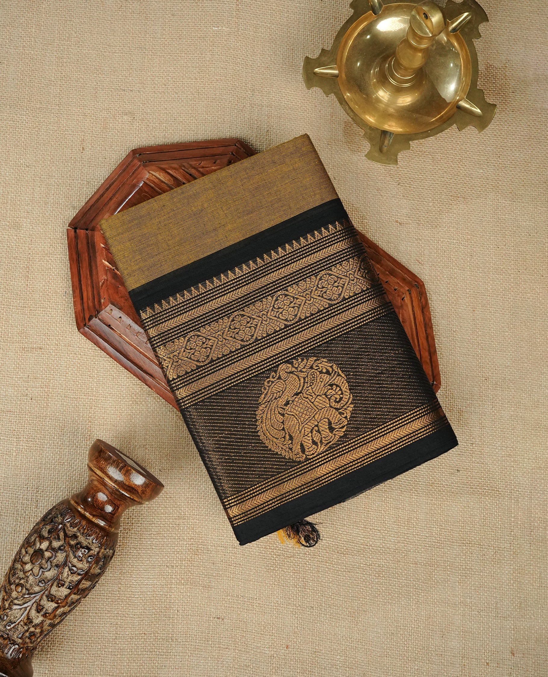 Olive colour chettinad cotton saree featuring Elegant plain body,Contrast Black colour with Gold zari border, comes with matching blouse piece.