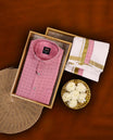Pink colour MCR full sleeve shirt with delicate printed motifs, paired with a classic white dhoti featuring an elegant golden zari kara and a matching pink printed border.