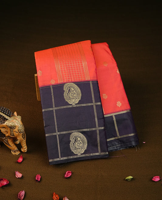 Reddish orange colour semi wedding silk saree featuring gold zari stripes with buttas on body, contrast dark  purple colour with gold zari check & motifs border on body, rich pallu comes with matching blouse piece