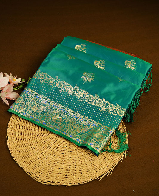 Green colour Banaras Satin Crepe saree featuring gold zari floral motifs on the body, a richly woven traditional border with intricate gold zari detailing, and paired with a matching blouse.
