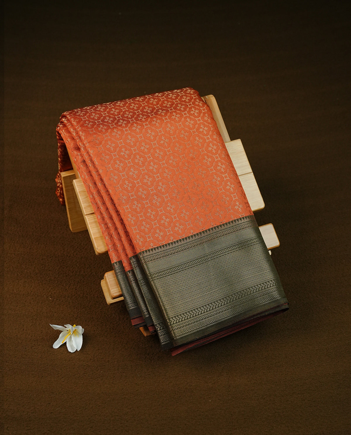 Rust orange colour semi silk saree featuring gold zari circle patterns on body, contrast olive green colour with traditional border on body, grand pallu comes with matching blouse piece