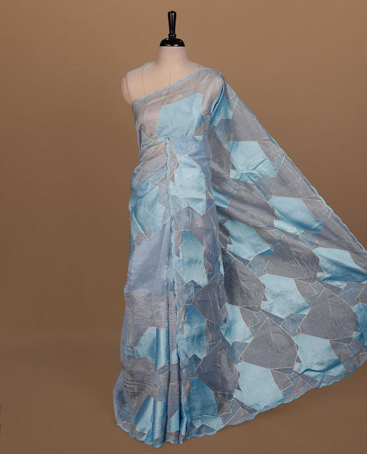 Blue colour Organza designer saree featuring a thread geometric pattern across the body, enhanced with a piping border and cut beats work on matching blouse piece.