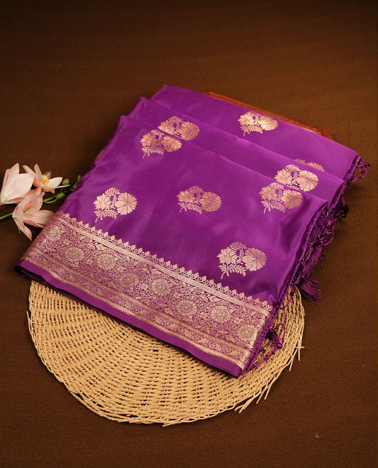 Purple colour Banaras Satin Crepe saree featuring gold zari buttas on the body, a richly woven traditional border with gold zari detailing, and paired with a matching blouse.