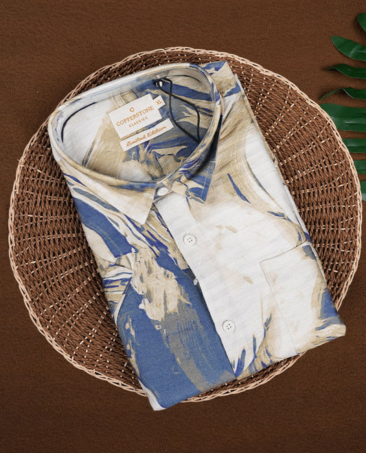 Off white colour shirt features a bold abstract print in blue and white tones, With short sleeves and a button-down front, its made from textured fabric, offering a stylish and modern look.