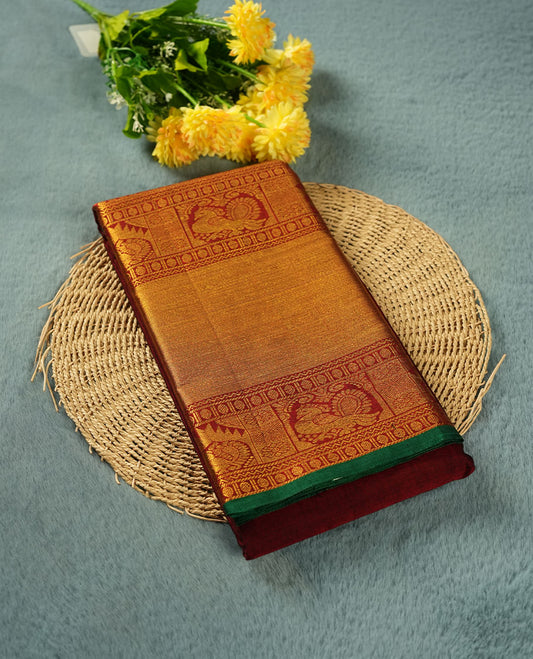 Dark red colour Narayanapattu cotton saree featuring a self coloured body, contrast Green colour with gold zari border and pallu, pairing a matching blouse piece.