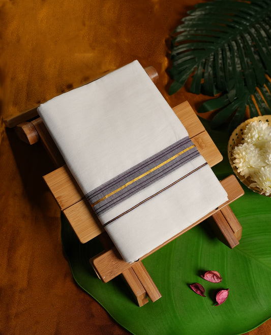 White colour cotton dhoti featuring a stylish dark purple border with golden zari highlights, blending traditional charm with modern elegance.