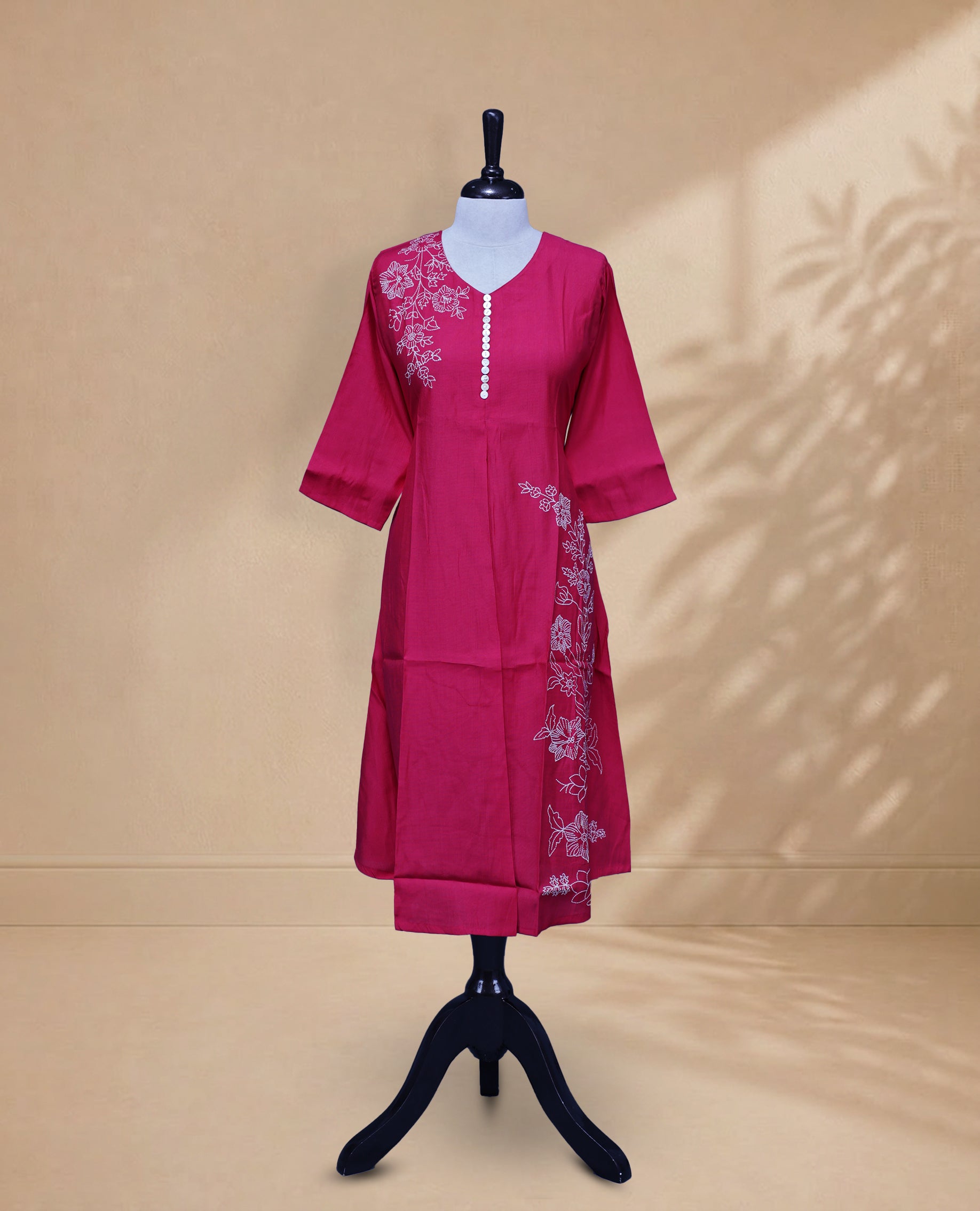 Rani Pink Kurti featuring a Floral Prints On body, a U-shaped neckline adorned with floral print and button work, and a 3/4-sleeve design.