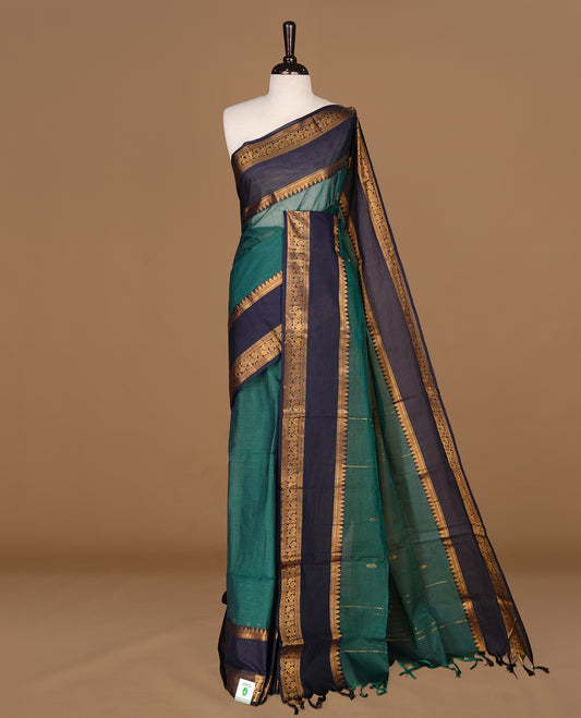Teal green Colour Chettinad cotton saree featuring Gold zari motifs on body , complemented by contrast blue colour with traditional border, comes with matching blouse piece.