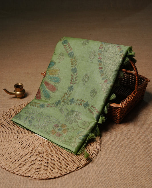 Pastel green colour pure tussar silk saree featuring elegant antique zari kodi patterns across the body, designed with a graceful borderless finish for a refined look. Paired with a matching blouse piece.