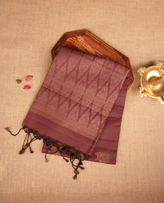 Chocolate Brown colour mayuri silk saree featuring gold zari motifs on body, complemented by self colour with traditional border with tassel at pallu, paired with matching blouse piece.