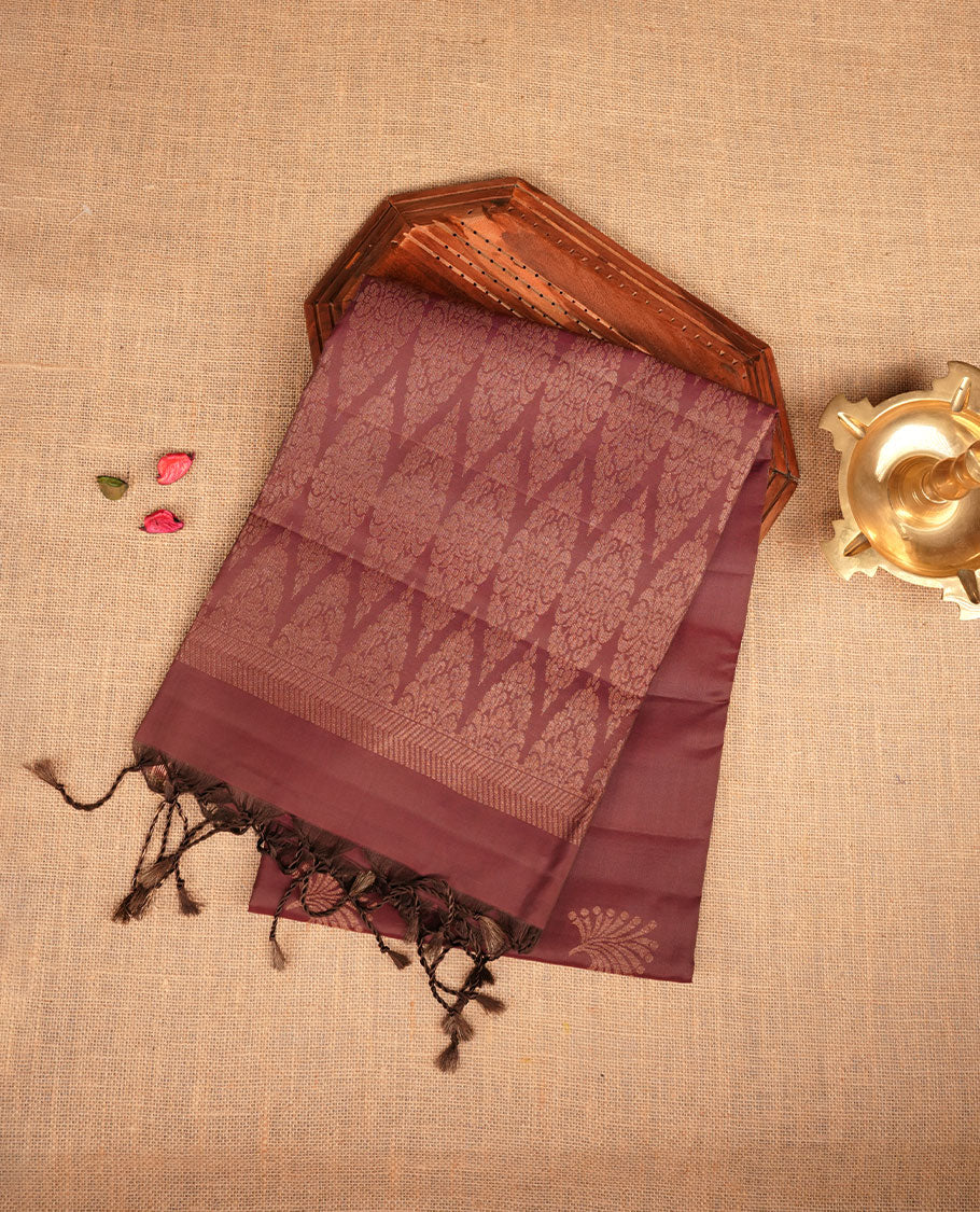 Chocolate Brown colour mayuri silk saree featuring gold zari motifs on body, complemented by self colour with traditional border with tassel at pallu, paired with matching blouse piece.
