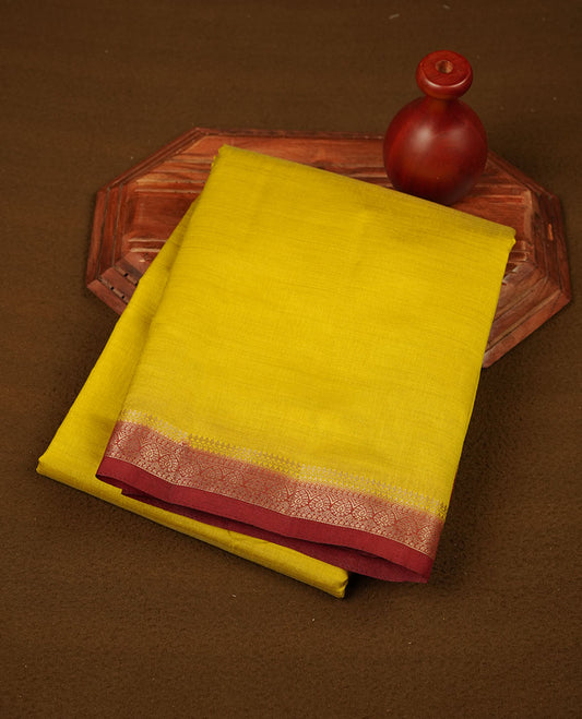 Olive colour tussar saree featuring elegant plain body, contrast Maroon colour gold zari border and comes with matching blouse piece.