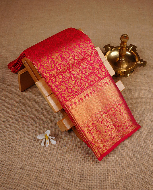 Red colour kancheepuram silk saree featuring gold zari pattern across body, complemented by selfcolour border traditional zari border, paired with matching blouse piece.