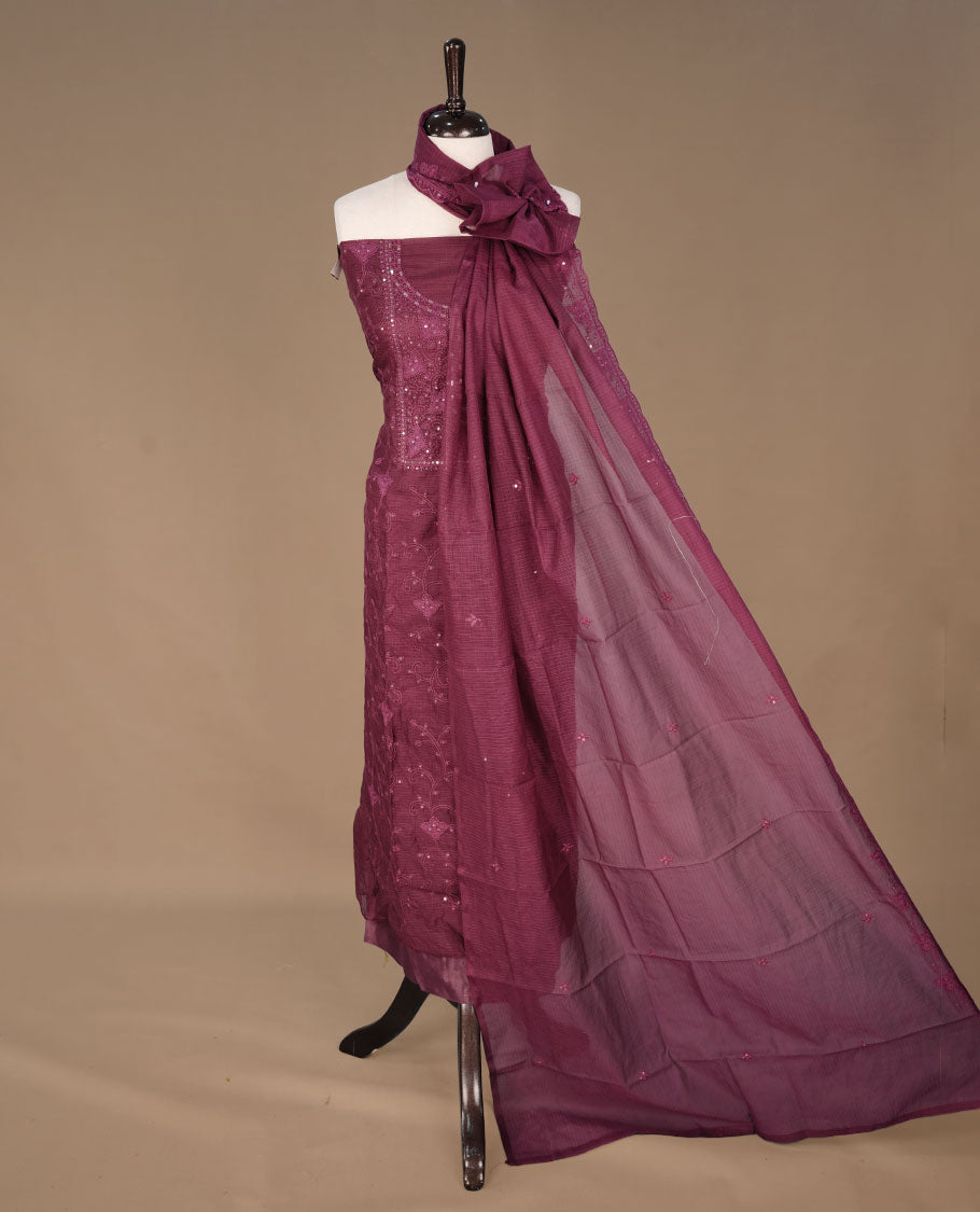 Burgundy colour churidhar material featuring self colour thread and sequins work on body, paired with matching bottom and Dupatta.