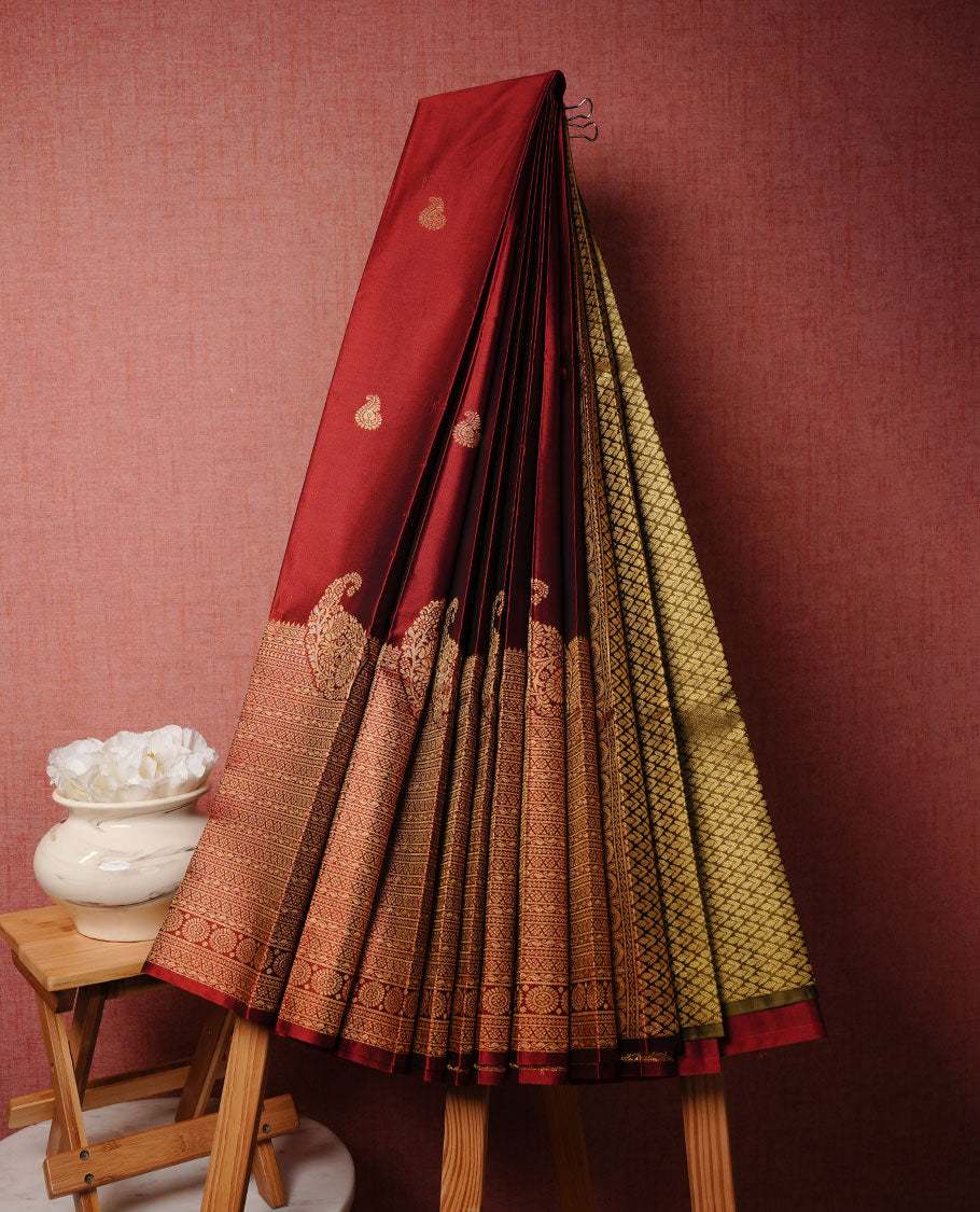 Saffron red colour soft silk saree featuring Gold zari motifs on body, complemented by self colour with traditional border, paired with matching blouse piece.