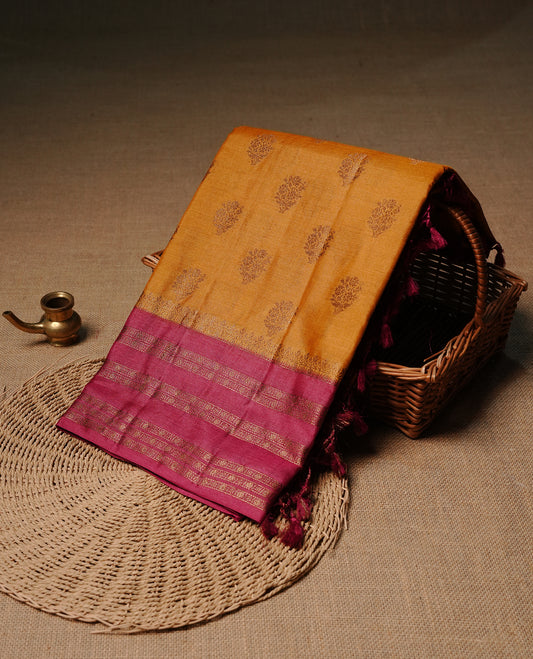 Mustard colour pure tussar banaras silk saree featuring gold zari motifs on body, highlighting contrast Magenta colour with zari border, paired with matching blouse piece.