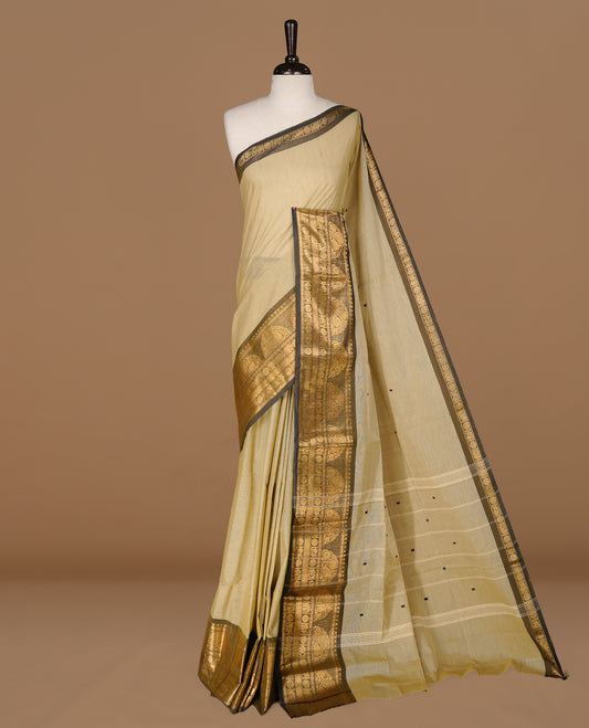 Grey beige colour Chettinad cotton saree featuring motifs on body , complemented by contrast Black colour with zari border, comes with matching blouse piece.