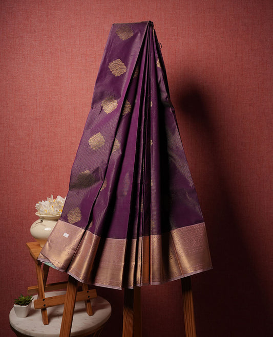 Purple colour semi silk saree highlighting gold zari strip pattern  and motifs across body, featuring contrast lavender colour border with gold zari pattern, comes with matching blouse .