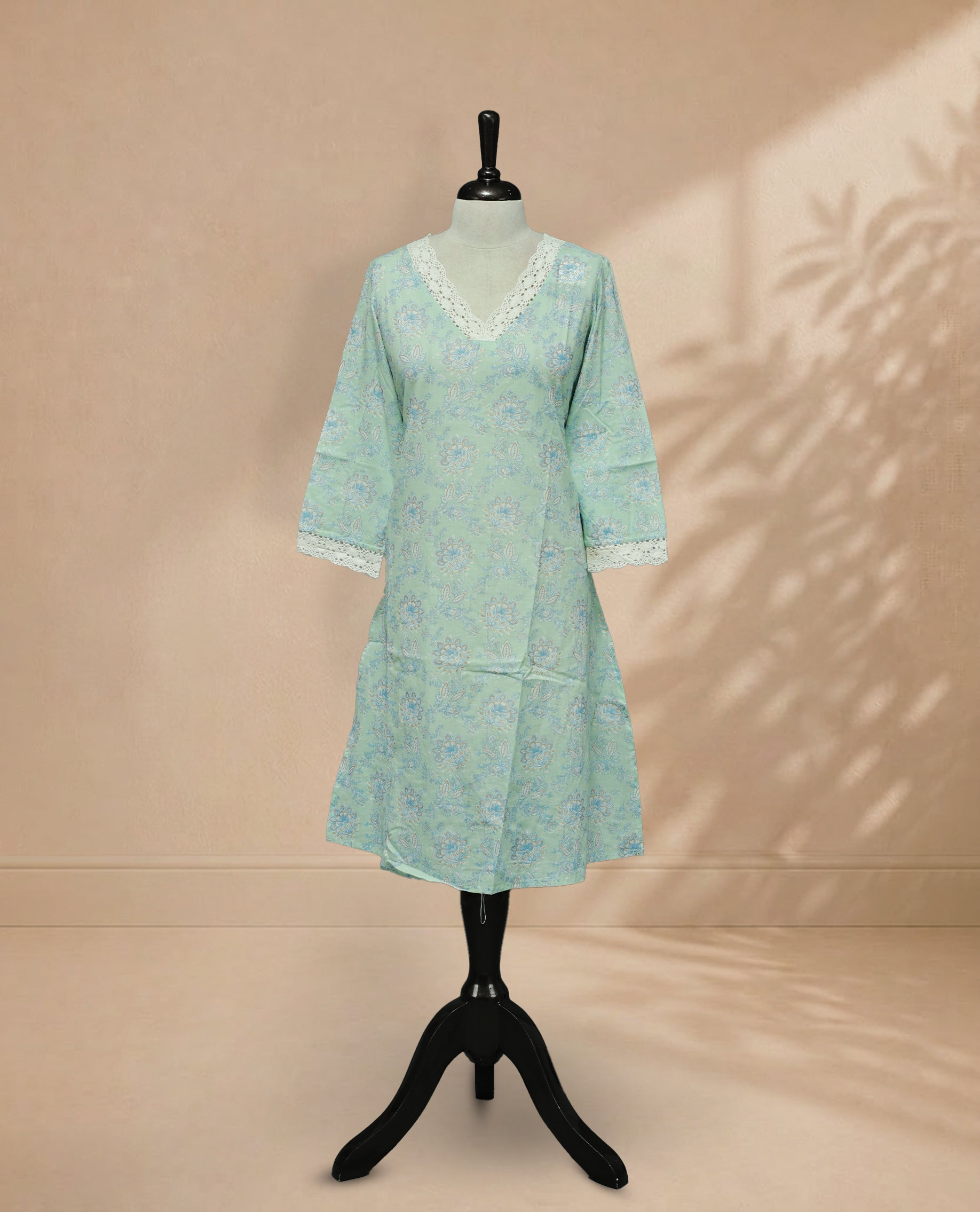 Mint Colour kurti featuring a classic V-shaped Laces neckline, Floral Pattern on the body,  Comes With sleeves.