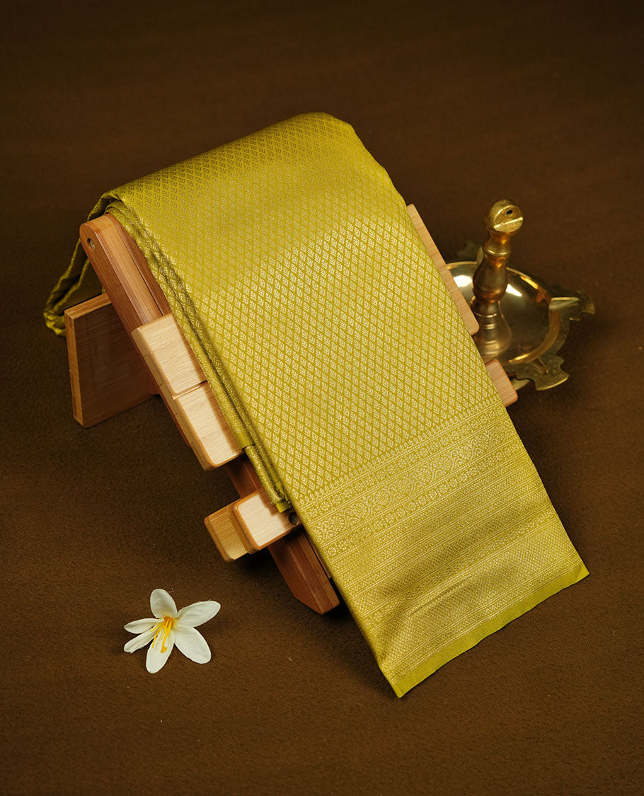 Lemon colour semi soft silk brocade saree with all-over fine geometric weave, detailed traditional pallu, and a matching blouse.