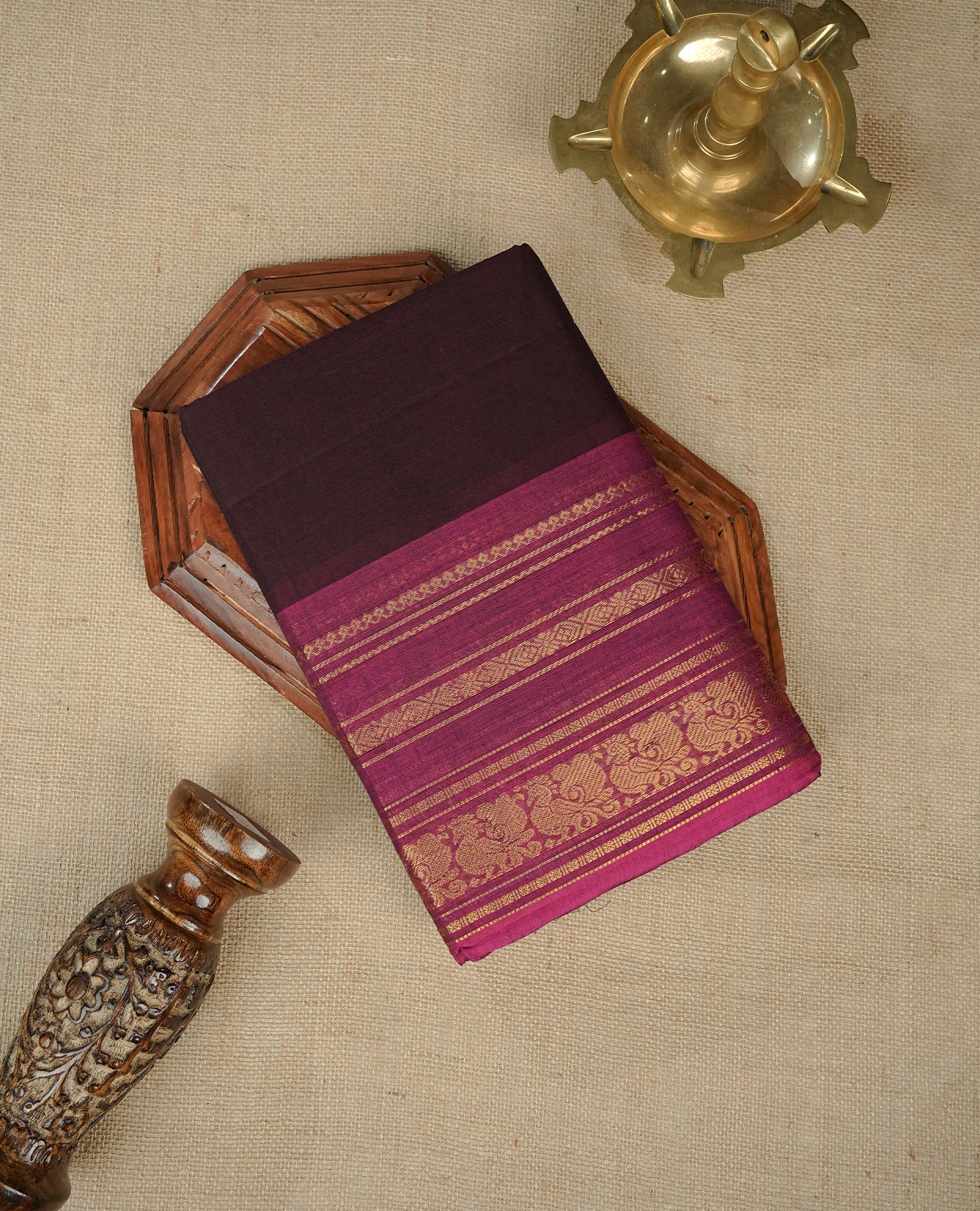 Dark Brown colour chettinad cotton saree featuring elegant plain body, Contrast Magenta colour with Gold zari border, comes with matching blouse piece.