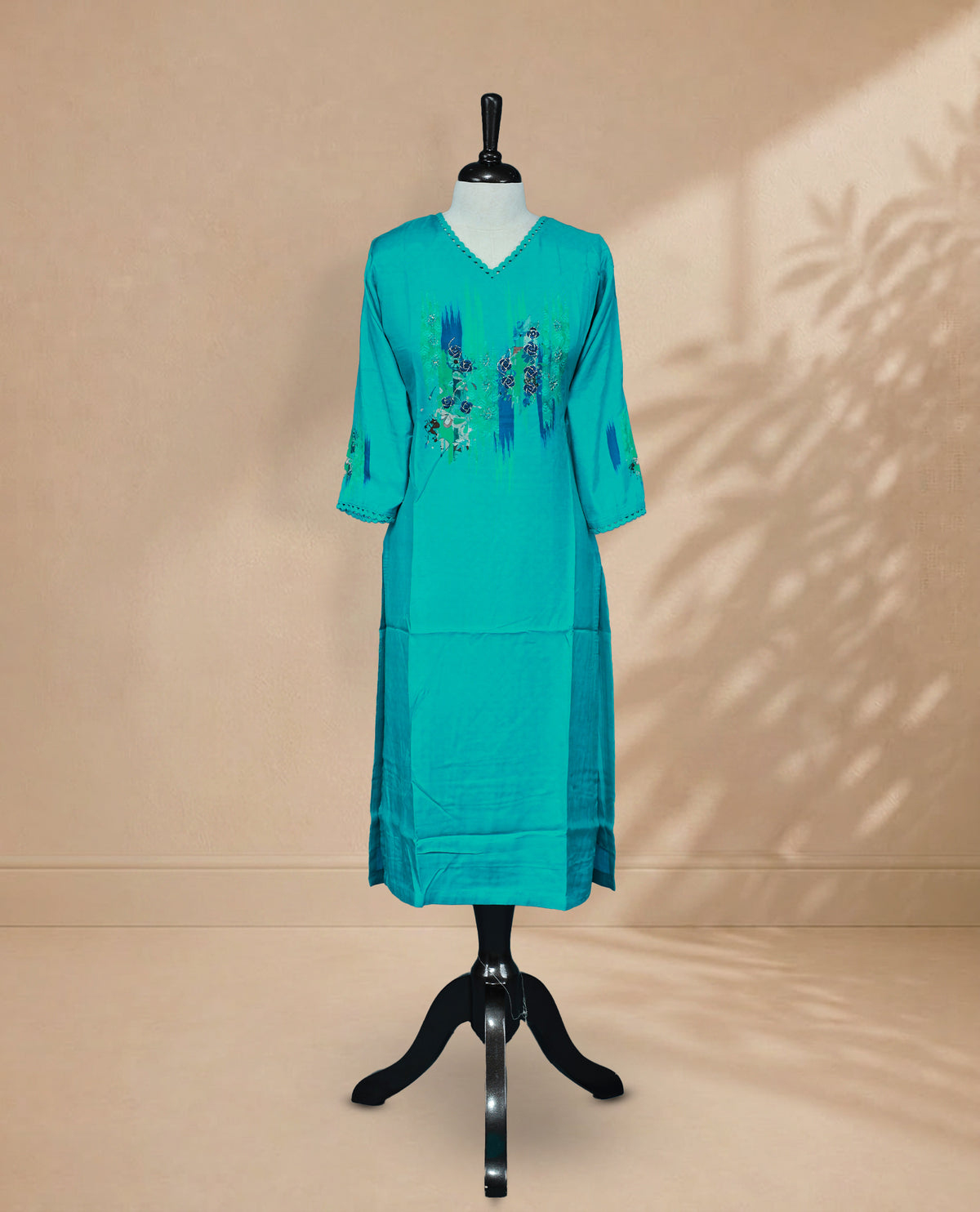 Teal Blue Colour Kurti featuring Floral embroidered detailing on Chest Side, a V-shaped neckline with lace detailing, and 3/4 sleeves with matching lace accents.