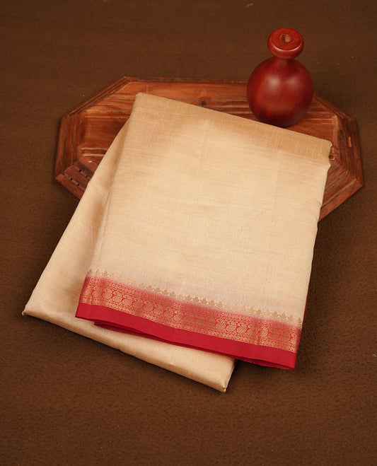 Cream colour tussar saree featuring elegant plain body, contrast Red colour gold zari border and comes with matching blouse piece.