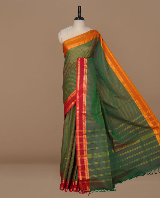 Green colour chettinad cotton featuring gold zari check pattern on body , complemented by contrast Maroon colour with gold zari border, paired with matching blouse piece.