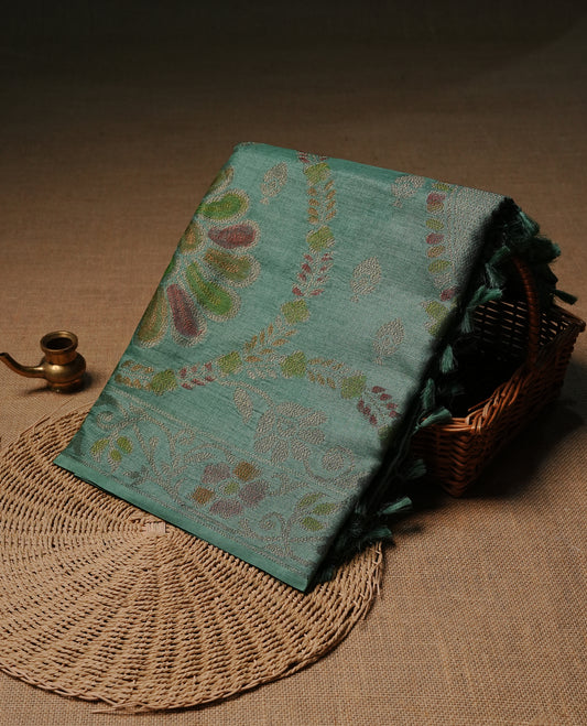 Pastel green colour pure tussar silk saree featuring elegant antique zari kodi patterns across the body, designed with a graceful borderless finish for a refined look. Paired with a matching blouse piece.