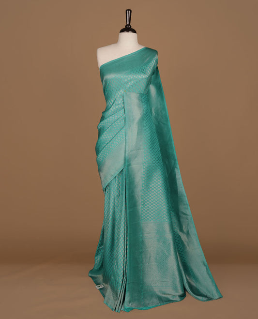 Aqua colour Semi Banaras Katan saree featuring Antique zari motifs on across body, complemented by self colour zari border, paired with matching blouse piece.