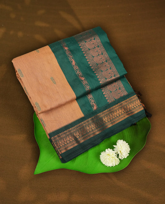 Bronze Orange colour Kalyani cotton saree with intricate small motifs all over, paired with a contrasting dark green rich zari woven border and pallu & Comes with a matching blouse piece