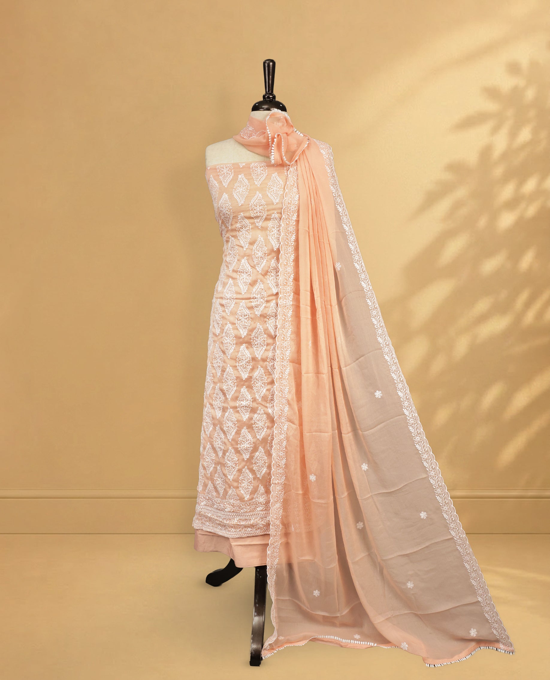 Light Peach colour Salwar Material Featuring White colour Thread Pattern on body, paired with matching bottom & elegant Dupatta.