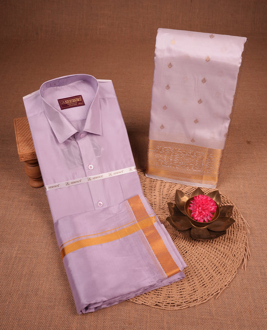 Violet colour shirt and dhoti with gold colour border, paired with matching colour silk saree featuring gold zari buttas and traditional border paired with matching blouse piece.