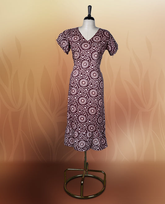 Dark maroon colour nightwear with intricate floral prints in circular patterns in beige colour, Designed with a V neckline, short sleeves, and a flared hemline. Ideal for casual outings, workwear, or ethnic inspired looks.