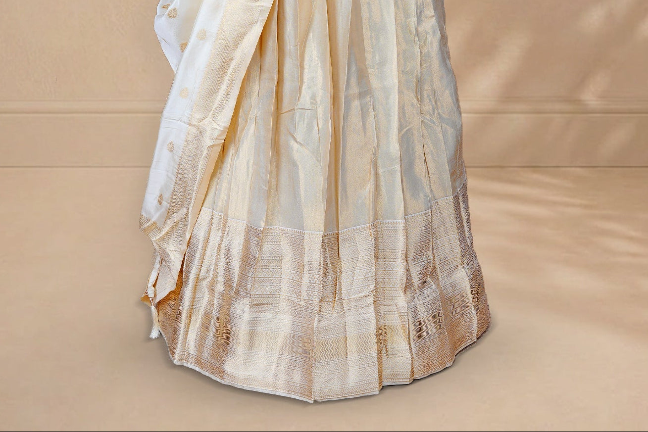 Golden colour Half saree featuring Plain skirt with Traditional zari on self colour border, Unstitched Blouse and matching dupatta.