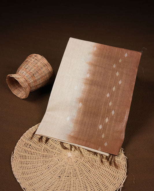 Cream & light brown dye pattern colour semi jute saree highlighting white stripped body, without border and paired with matching blouse.