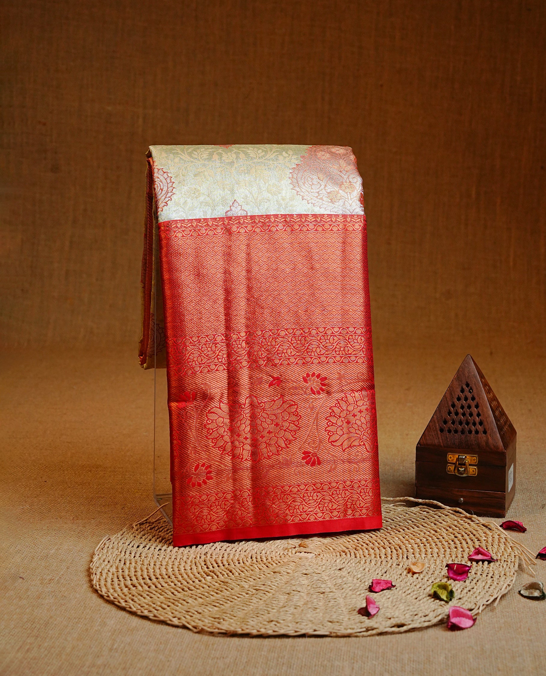 Light gold  colour Semi tissue silk saree featuring Gold zari kodi & Red zari Motifs on body, Contrast Red colour with traditional border, paired with matching.
