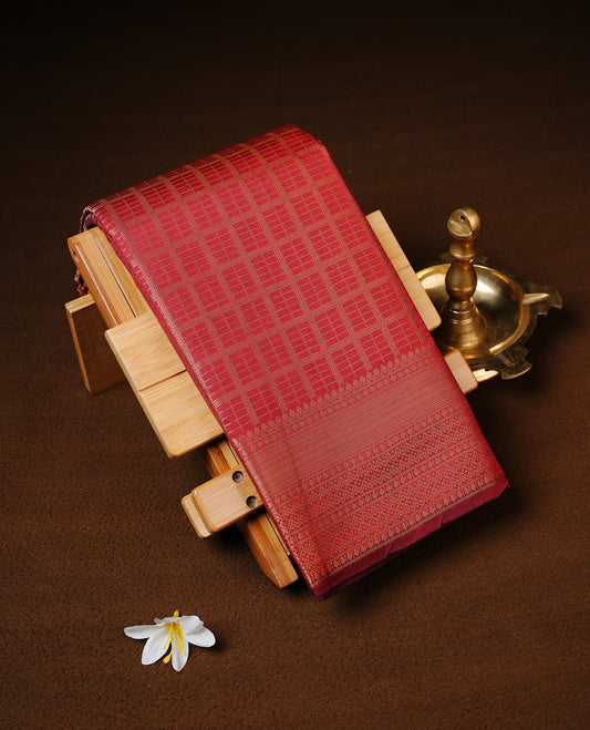 Maroon colour Semi Wedding silk saree featuring gold zari Check pattered body, complemented by self colour with traditional border, paired with matching blouse piece.