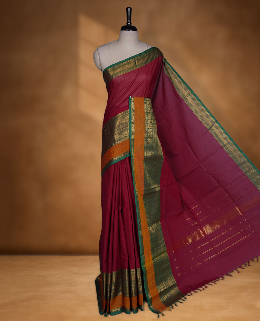 Red colour chettinad cotton saree featuring Elegant plain body highlighting contrast Green and mustrad colour colour with gold zari traditional border, pallu and paired with matching blouse piece.