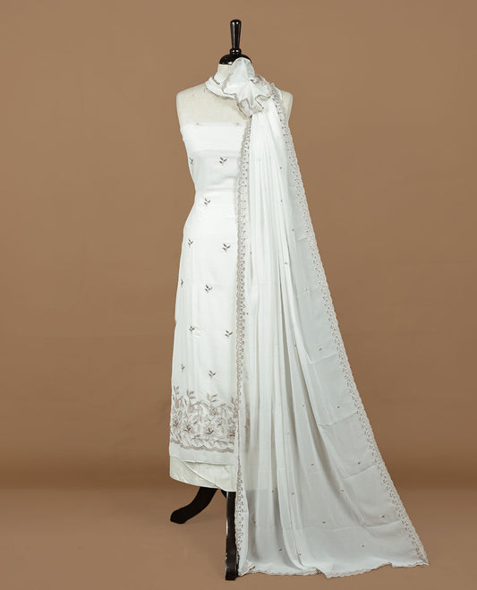 White colour churidhar material featuring gold thread floral pattern on body, paired with matching bottom & dupatta.