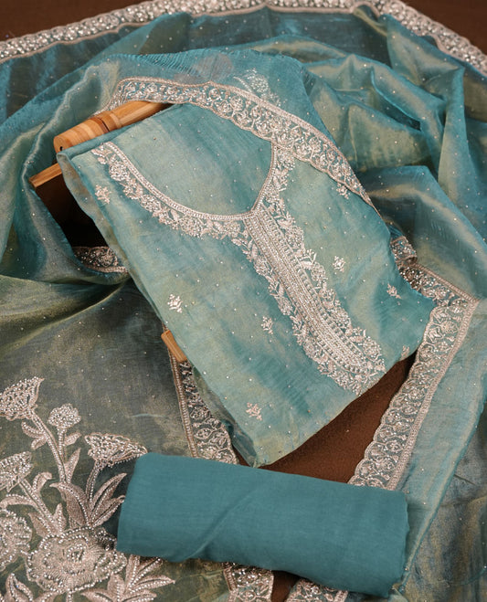 Powder blue colour churidar set with stone and thread embroidery and detailing, paired with matching pant and dupatta.