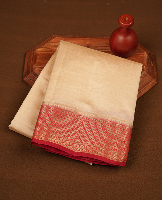 Cream colour tussar silk saree featuring elegant plain body, contrast Red colour border with gold zari, comes with matching blouse piece.