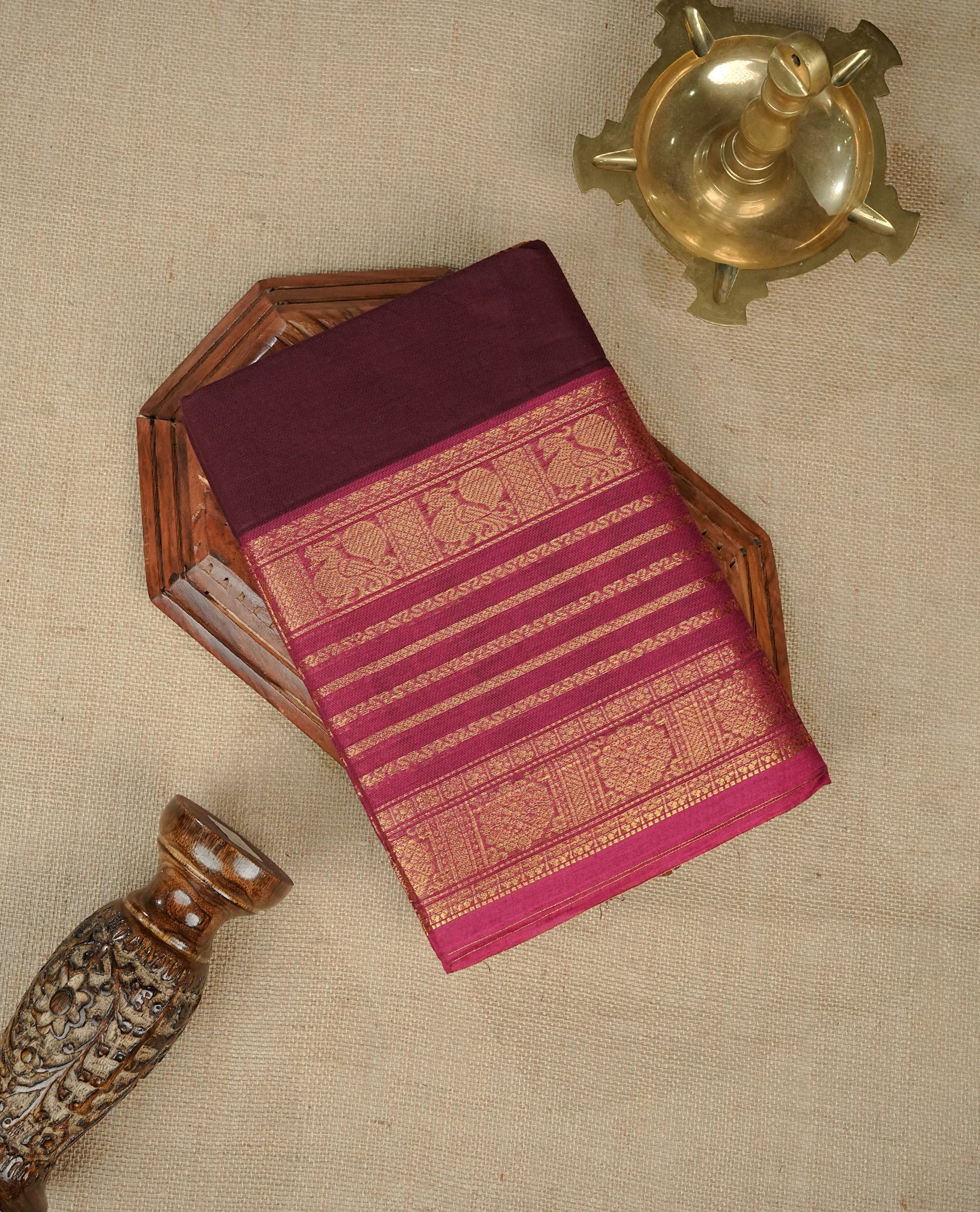 Grape colour chettinad cotton saree featuring Elegant plain body, complemented by contrast Magenta colour with gold zari strip & peacock border, comes with matching blouse piece.
