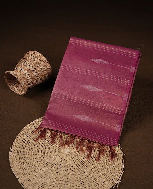 Burgundy colour semi jute saree highlighting gold zari stripped body with white motifs, without border and paired with matching blouse.