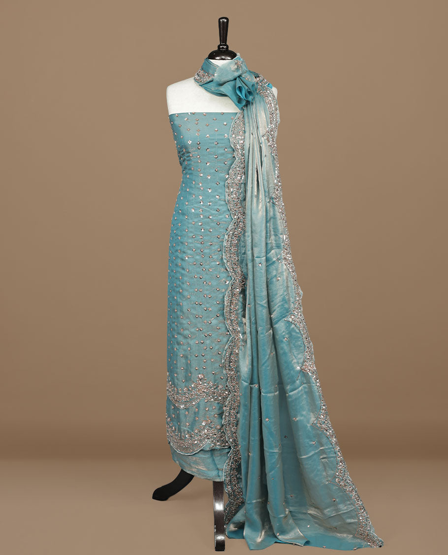 Sky blue colour churidhar material featuring cut beads and sequins work on the body, paired with a matching unstitched bottom and worked dupatta.