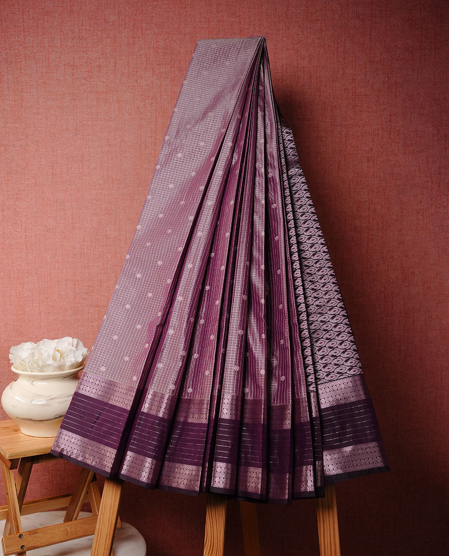 Lavender colour soft silk saree featuring rose Gold zari check & motifs on body, complemented by contrast purple colour with traditional border, paired with matching blouse piece.
