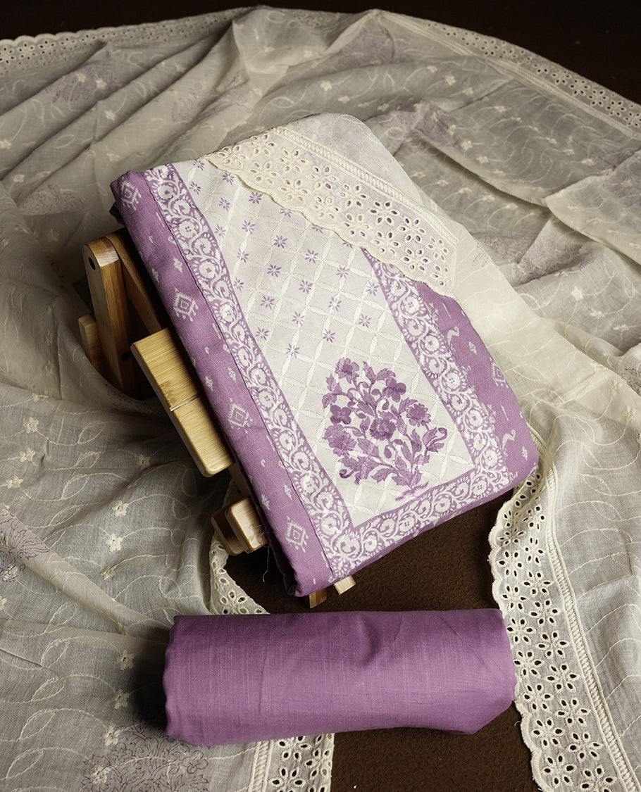Pastel purple and off white colour churidar material featuring elegant thread work on the neckline and floral motifs on the body, dupatta is adorned with delicate embroidered motifs and scalloped lace border & Comes with a matching bottom.