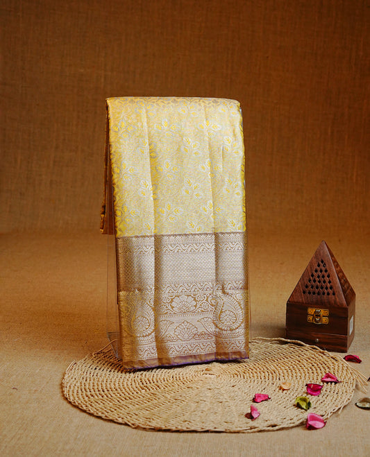 Pale Yellow colour Double shade Semi tissue silk saree featuring Gold & silver zari kodi pattern on body, contrast Violet colour with traditional border, paired with matching.