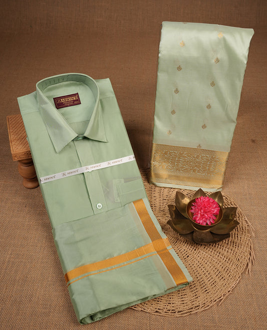 Pista colour shirt and dhoti with gold colour border, paired with matching colour silk saree featuring gold zari buttas and traditional border paired with matching blouse piece.