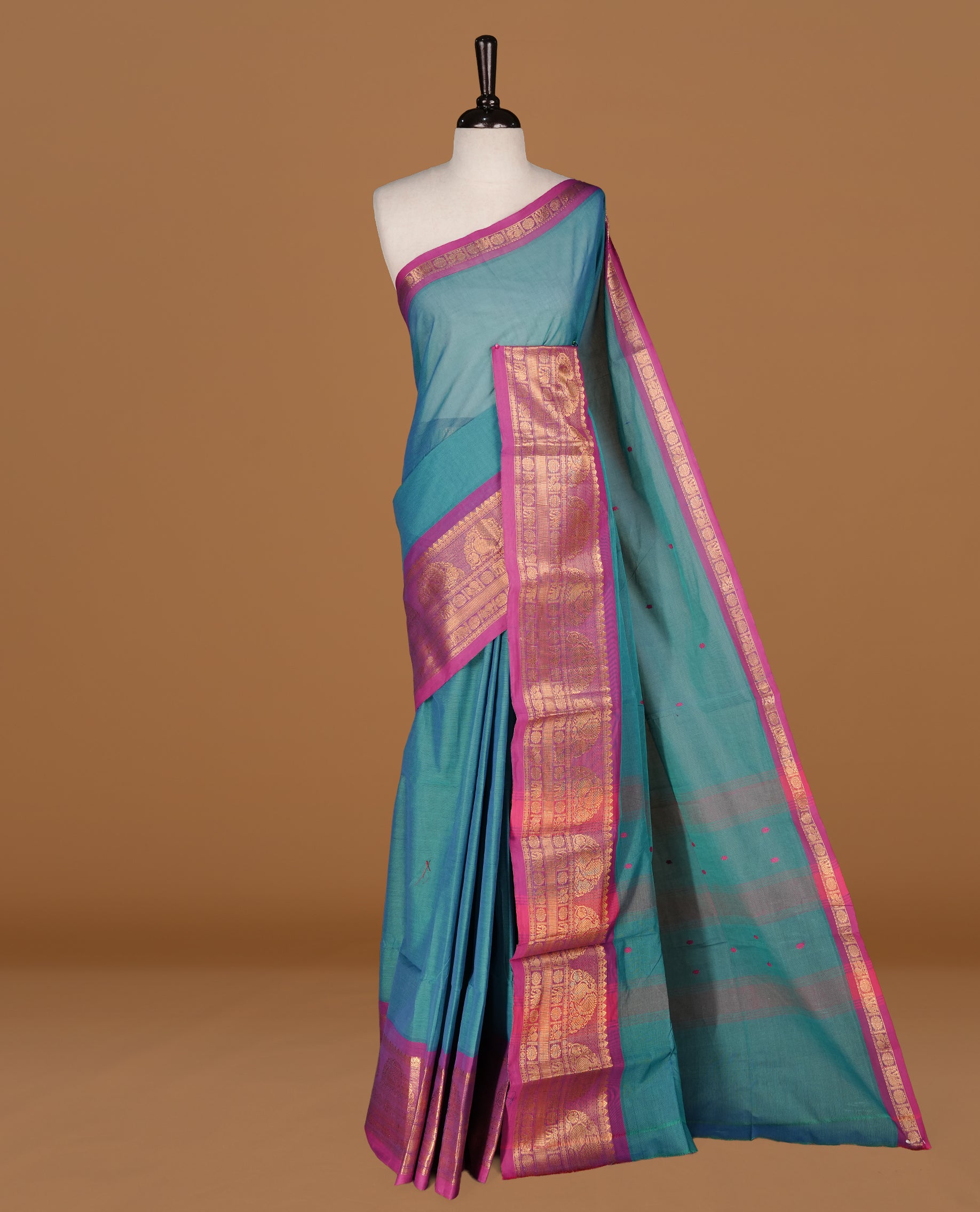 Teal colour Chettinad cotton saree featuring motifs on body , complemented by contrast Magenta colour with zari border, comes with matching blouse piece.